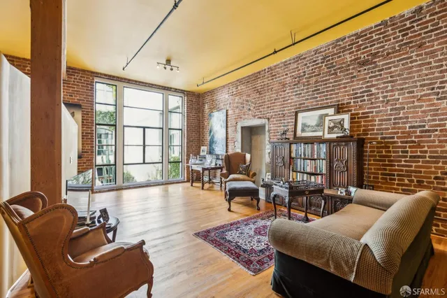 a living room with furniture and floor to ceiling windows
