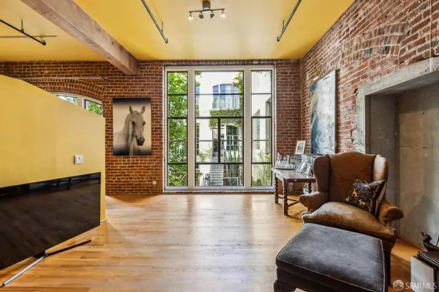 a living room with furniture window and wooden floor