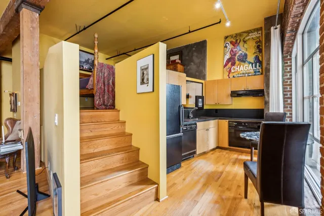 a view of a kitchen with a stove and a refrigerator