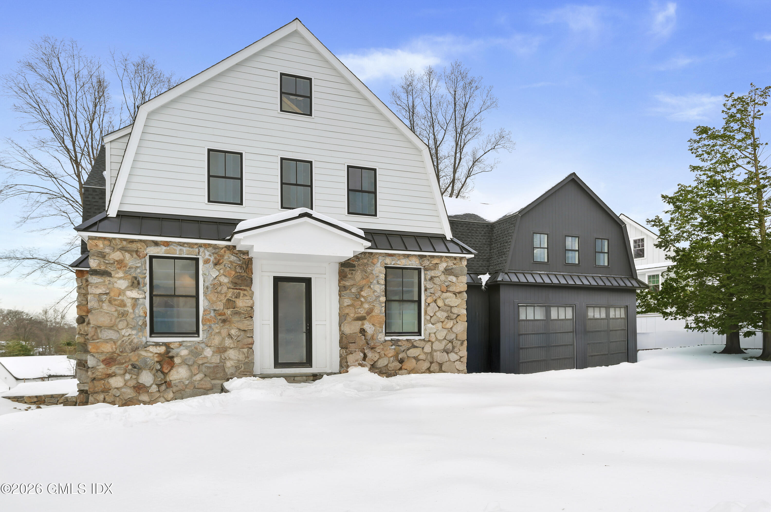 112 Sheep Hill Road Riverside, CT 06878 - Photo 2 of 30 a front view of a house with a yard and garage