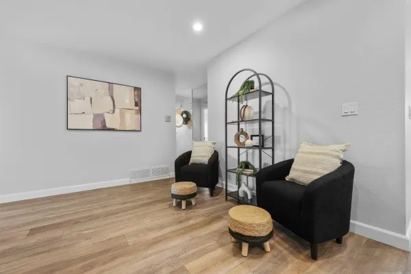 a living room with furniture a rug and a window