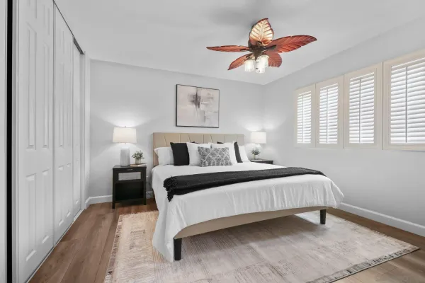 a bedroom with a bed and a chandelier