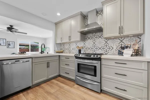 a kitchen with stainless steel appliances granite countertop a stove and a sink