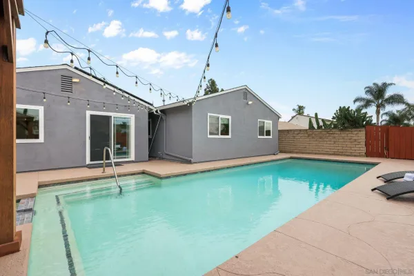 a view of a backyard with a sitting area and slide