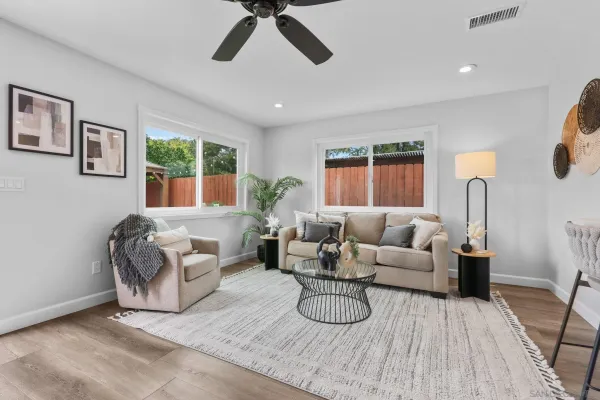 a living room with furniture and a wooden floor