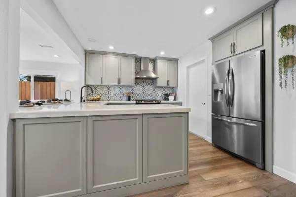 a kitchen with stainless steel appliances white cabinets and a refrigerator