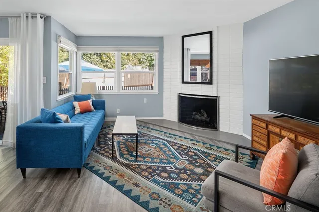 a living room with furniture fireplace and window