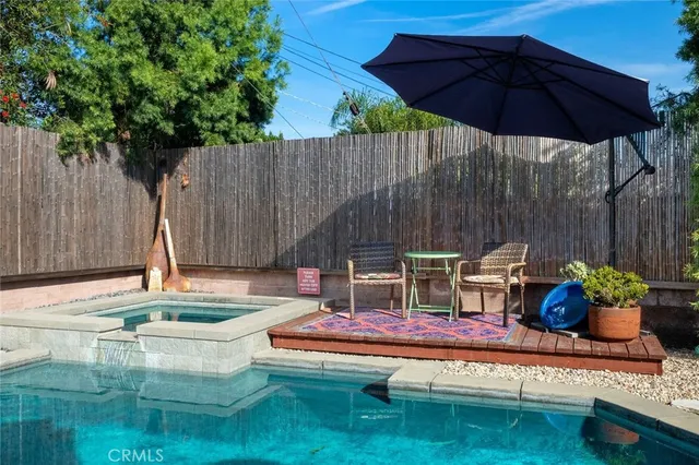 a backyard of a house with table and chairs