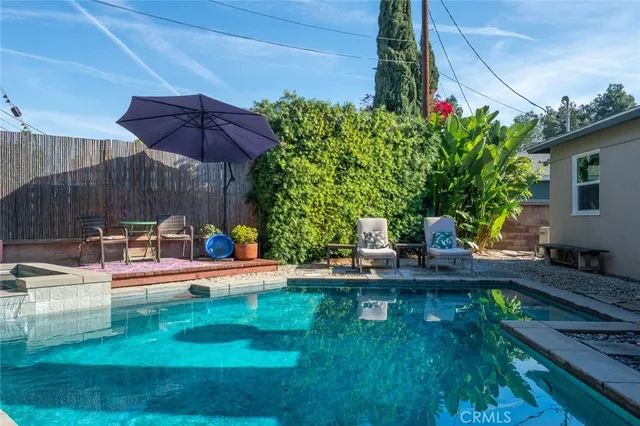 a view of a house with backyard and sitting area