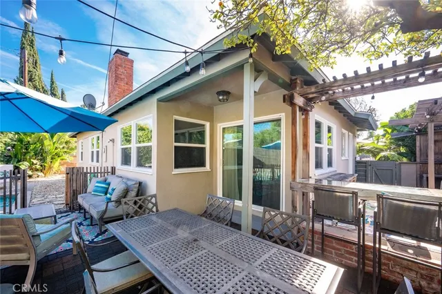 a patio with glass top table and chairs