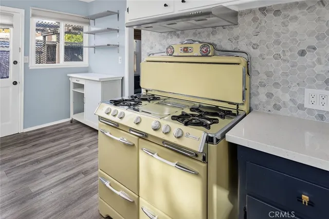 a white stove top oven sitting inside of a kitchen