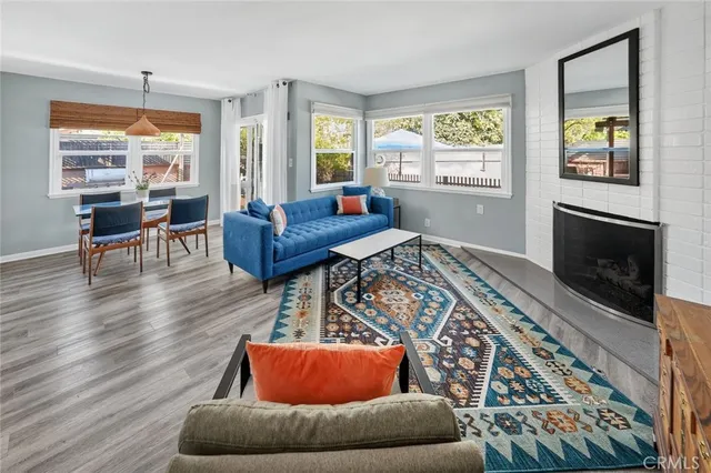 a living room with furniture fireplace and window