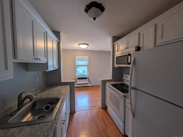 a kitchen with granite countertop a sink and appliances