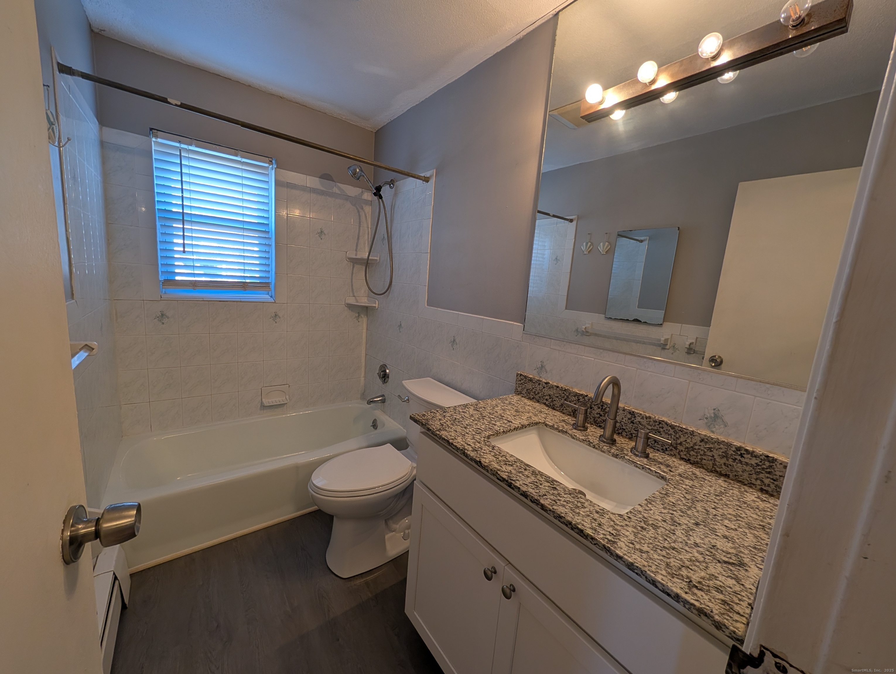 41 Balance Rock Road, Unit 16 Seymour, CT 06483 - Photo 10 of 13 updated bath, new flooring, commode, resealed tub and newer vanity