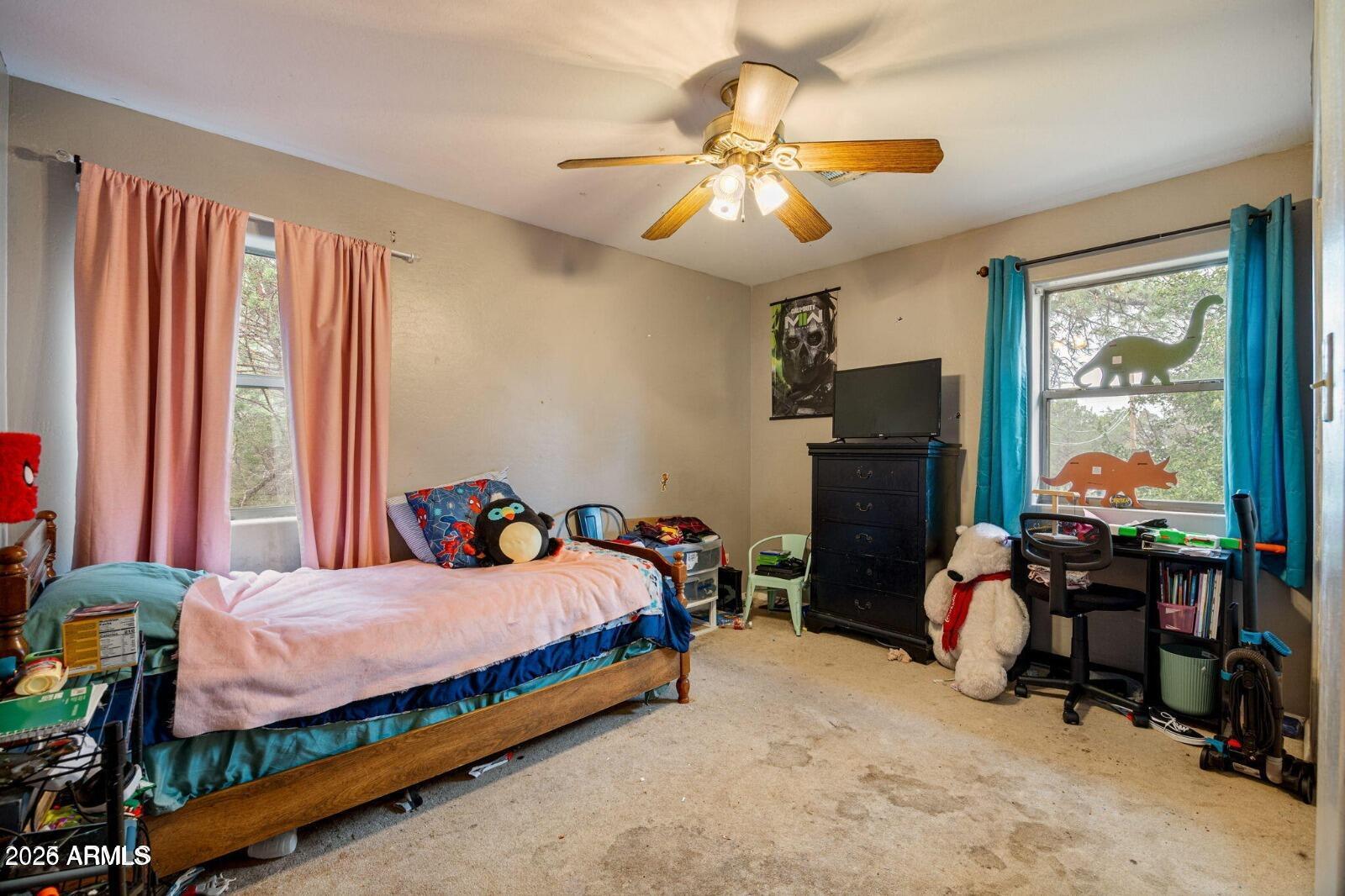 2870 Mustang Trail Overgaard, AZ 85933 - Photo 4 of 17 a bedroom with a bed and a chandelier