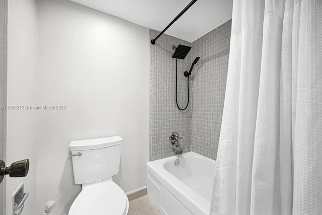 a bathroom with a toilet and a bath tub