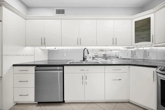 a view of a kitchen with a sink and dishwasher