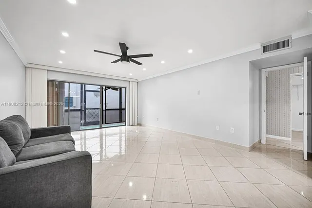 an empty room with a ceiling fan and window