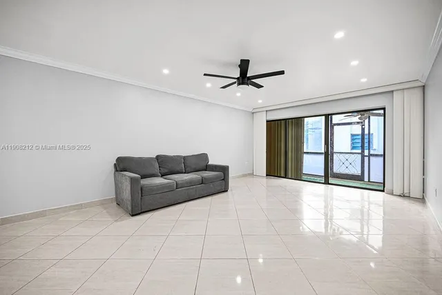 a living room with furniture and a ceiling fan
