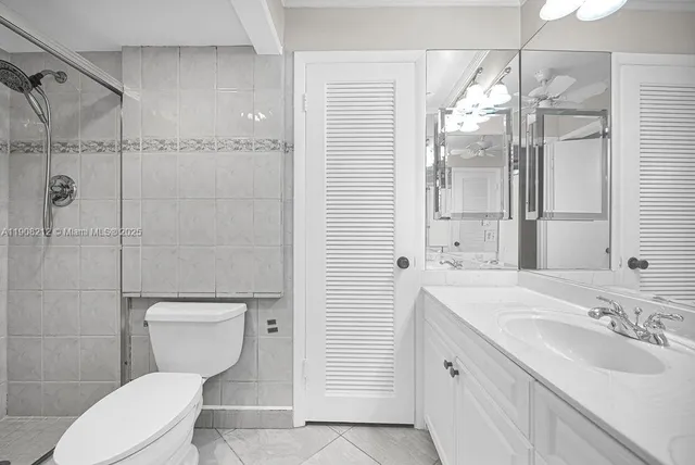 a white toilet sitting next to a bathroom sink