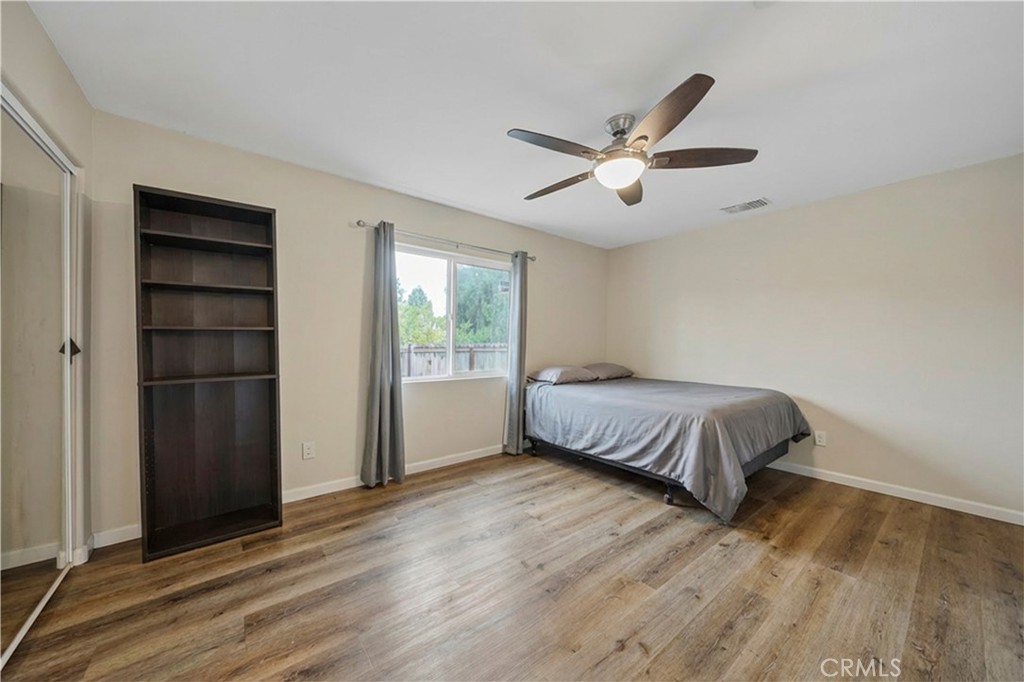 65 Tennessee Street Redlands, CA 92373 - Photo 16 of 23 a bedroom with a bed and a ceiling fan