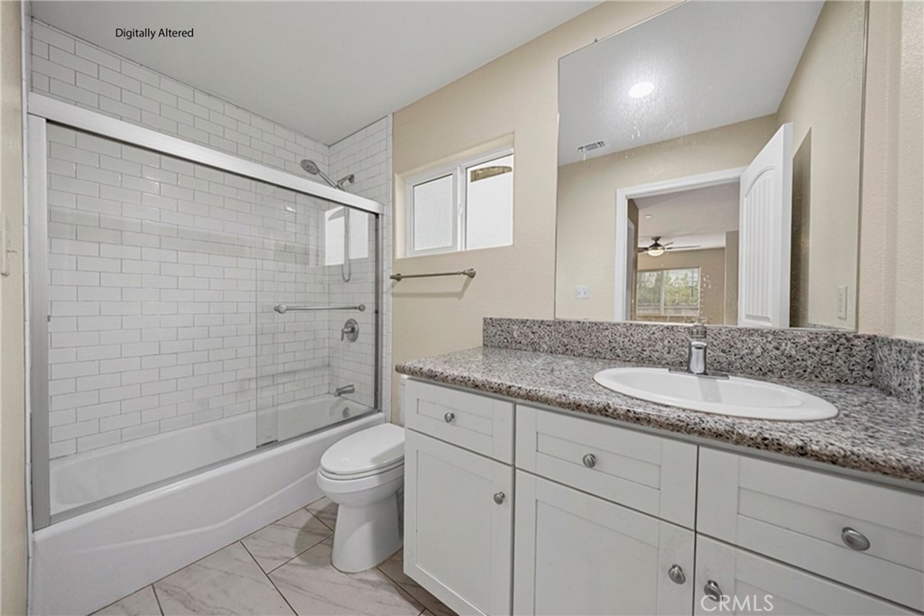 65 Tennessee Street Redlands, CA 92373 - Photo 17 of 23 a bathroom with a granite countertop sink a toilet and shower