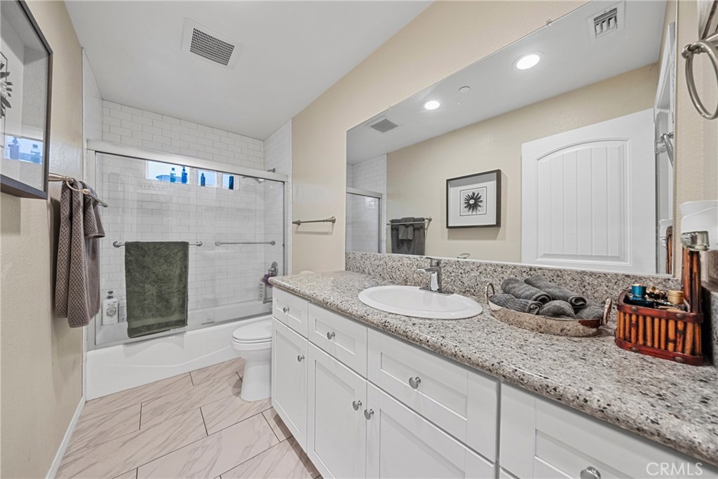 65 Tennessee Street Redlands, CA 92373 - Photo 18 of 23 a spacious bathroom with a granite countertop sink and a mirror