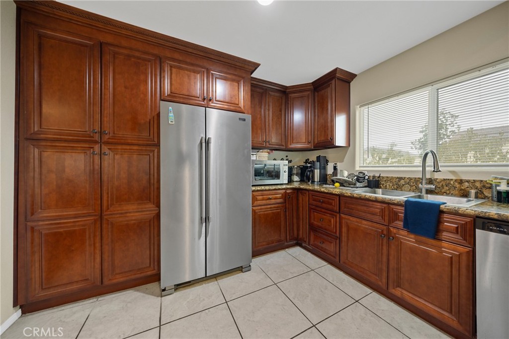 65 Tennessee Street Redlands, CA 92373 - Photo 7 of 23 a kitchen with stainless steel appliances granite countertop a refrigerator and a sink