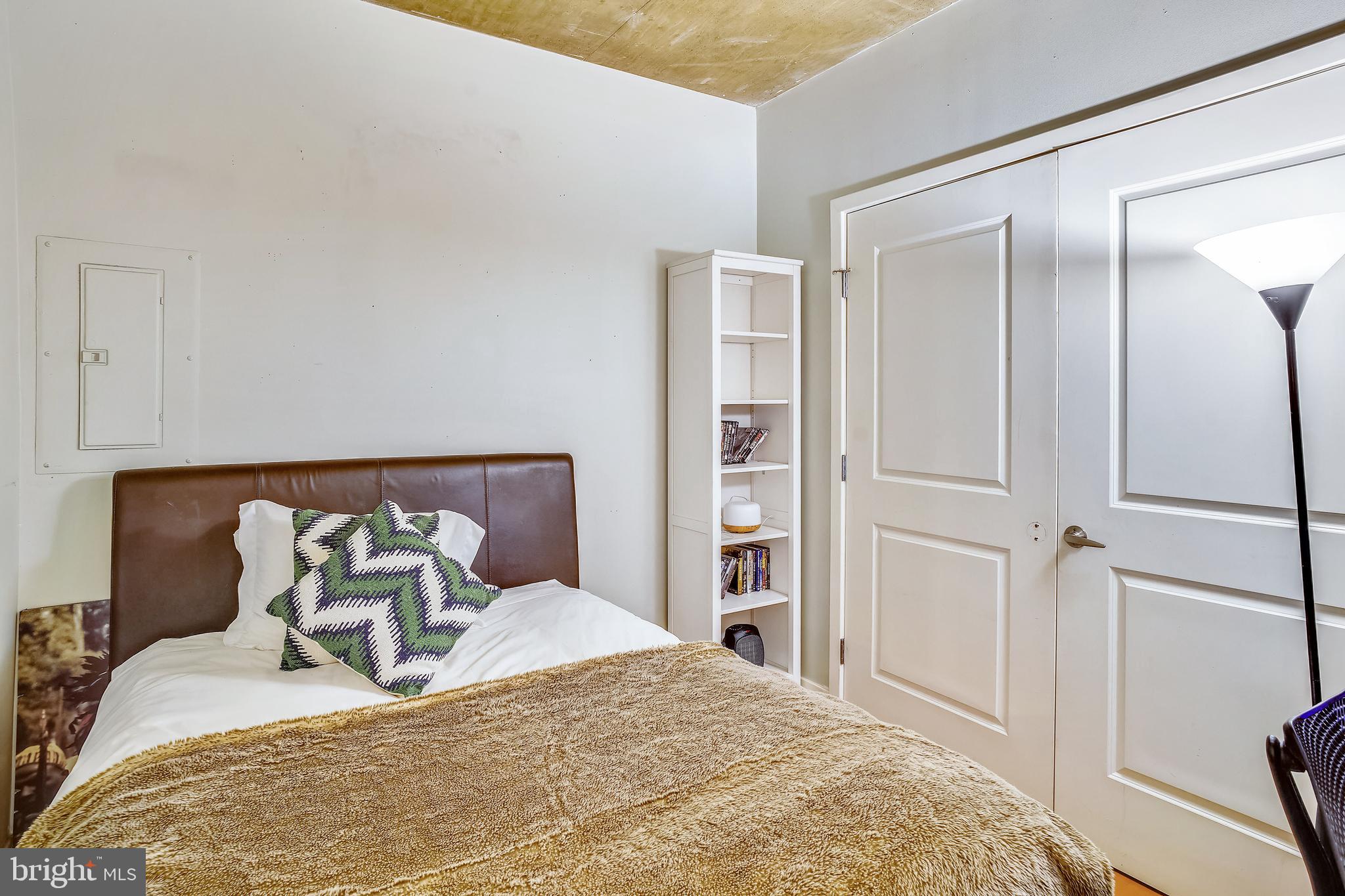 2125 14th Street Northwest, Unit 212 Washington, DC 20009 - Photo 18 of 21 a bedroom with a bed and closet