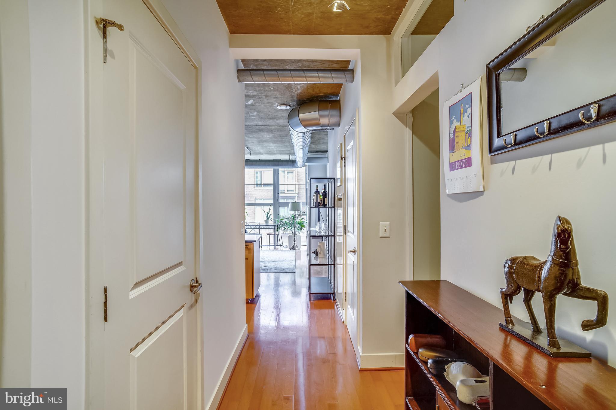 2125 14th Street Northwest, Unit 212 Washington, DC 20009 - Photo 5 of 21 a view of a hallway with furniture and wooden floor