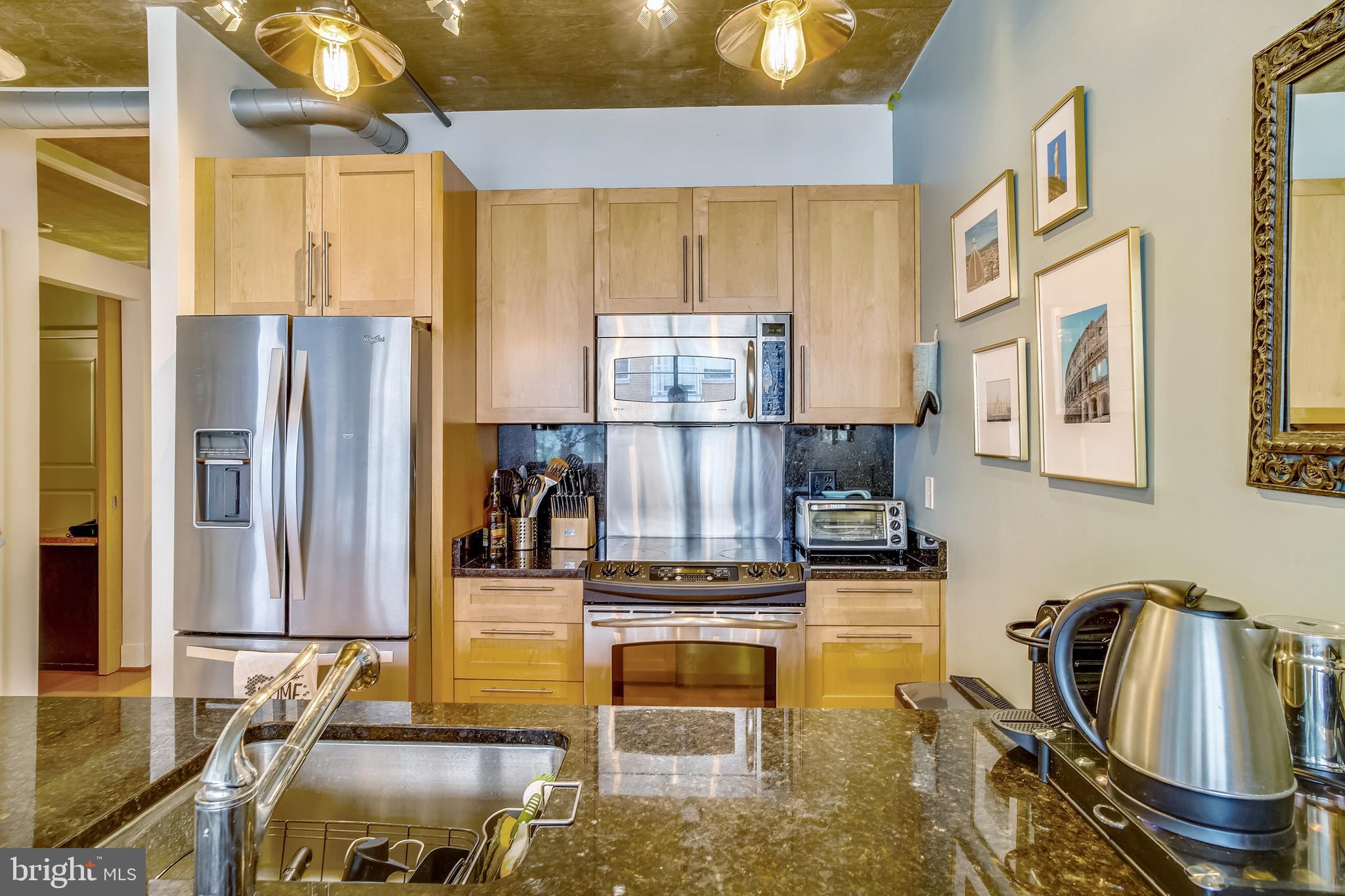 2125 14th Street Northwest, Unit 212 Washington, DC 20009 - Photo 9 of 21 a kitchen with stainless steel appliances granite countertop a refrigerator and a stove top oven