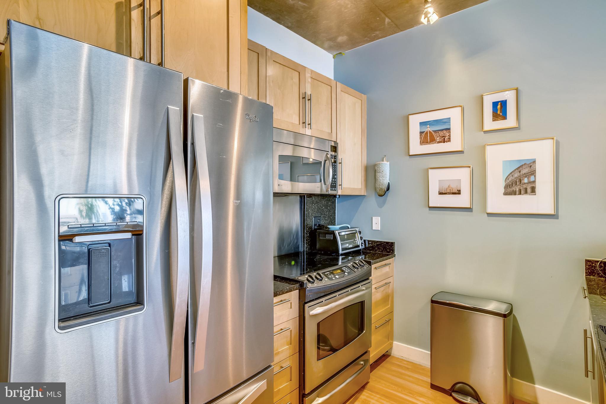 2125 14th Street Northwest, Unit 212 Washington, DC 20009 - Photo 10 of 21 a kitchen with stainless steel appliances granite countertop a refrigerator stove and sink