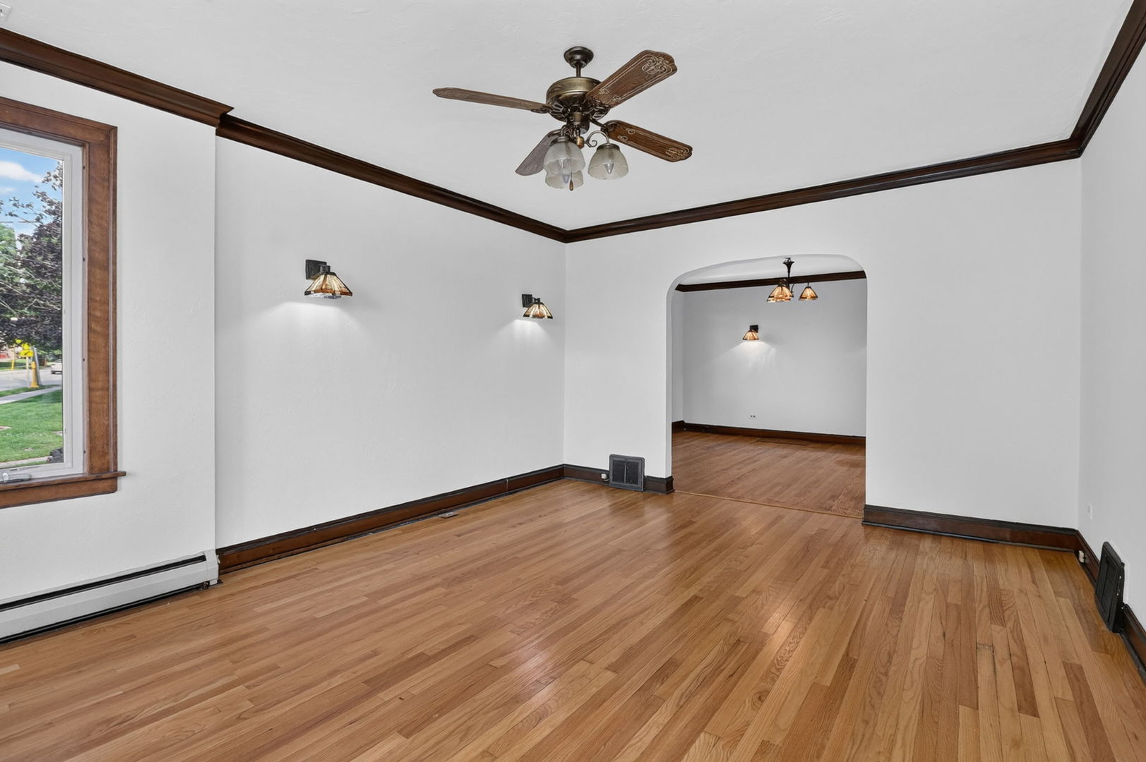 708 McCarthy Road Lemont, IL 60439 - Photo 3 of 14 a view of an empty room with wooden floor and a window