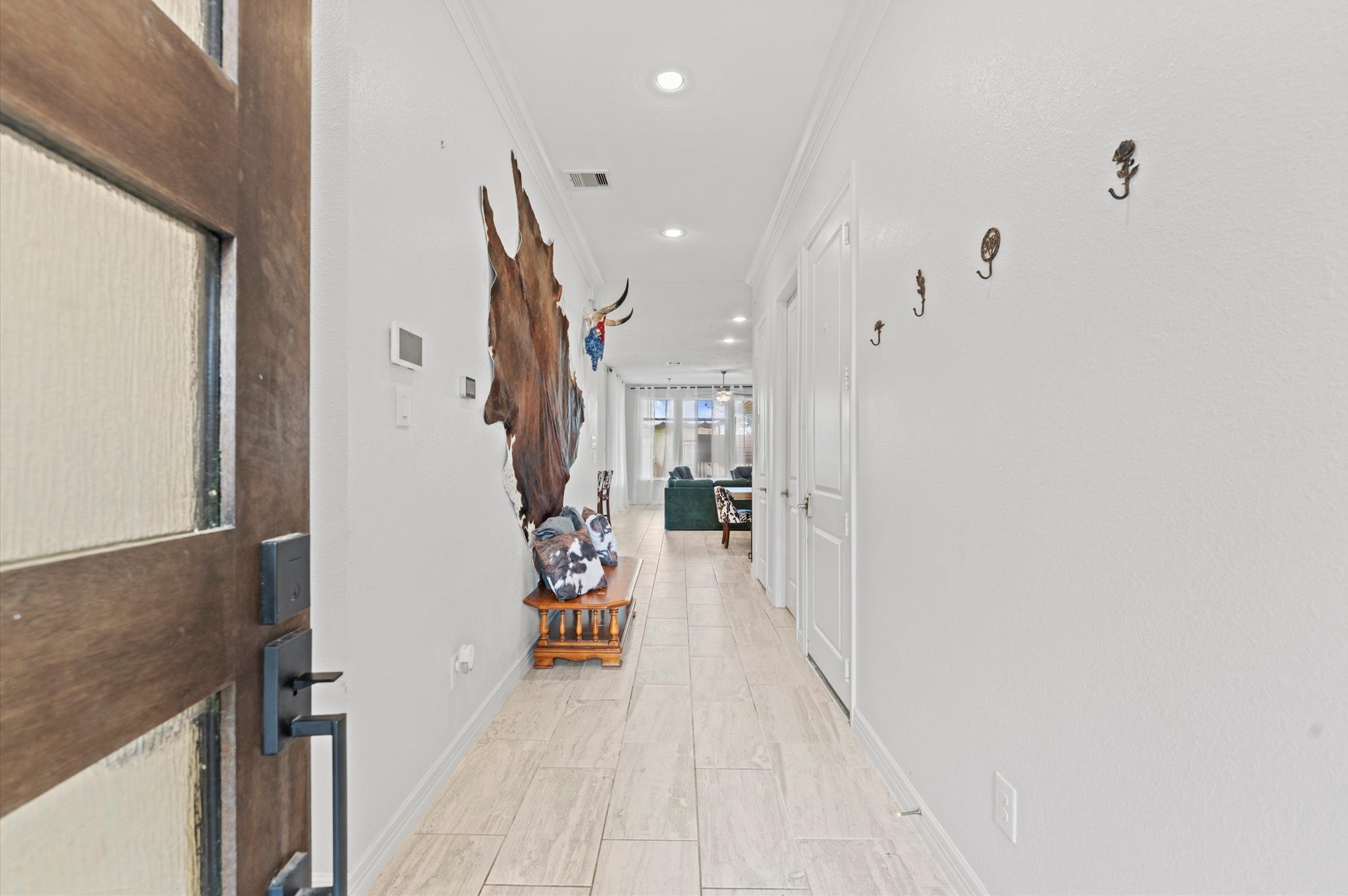 3510 Whitman Drive Rosharon, TX 77583 - Photo 4 of 25 This photo shows a welcoming hallway that leads to a bright living area, creating an inviting entrance to the home.