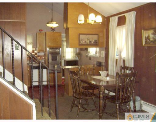 27 Sims Road Edison, NJ 08817 - Photo 4 of 9 a view of a dining room with furniture and a chandelier