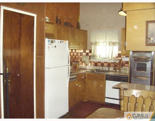 27 Sims Road Edison, NJ 08817 - Photo 5 of 9 a kitchen with granite countertop a refrigerator a stove a washer and dryer