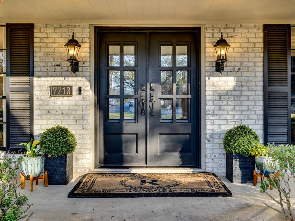 a building with potted plants in front of door