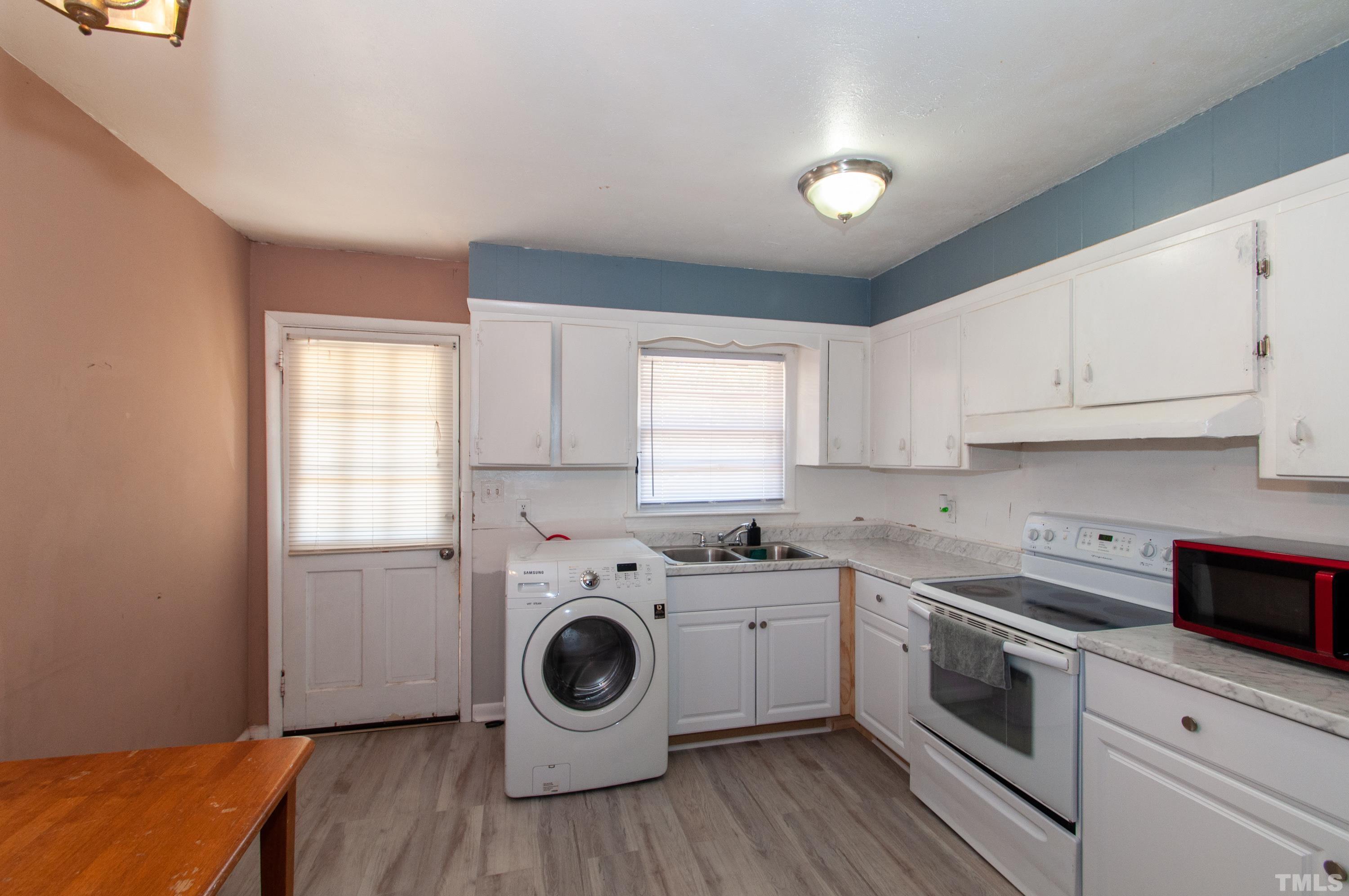 4260 Louisburg Road Raleigh, NC 27604 - Photo 10 of 22 a kitchen with a white stove top oven sink and cabinets
