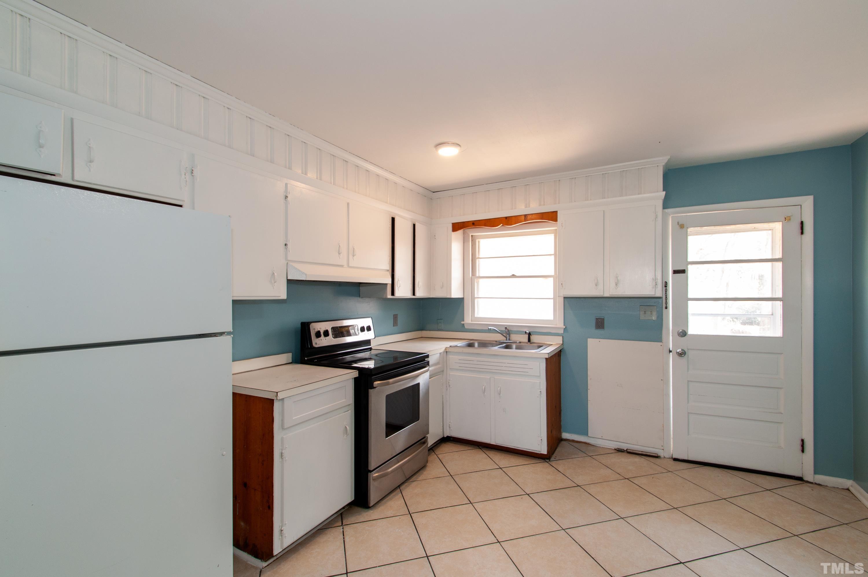 4260 Louisburg Road Raleigh, NC 27604 - Photo 11 of 22 a kitchen with a stove top oven sink and cabinets