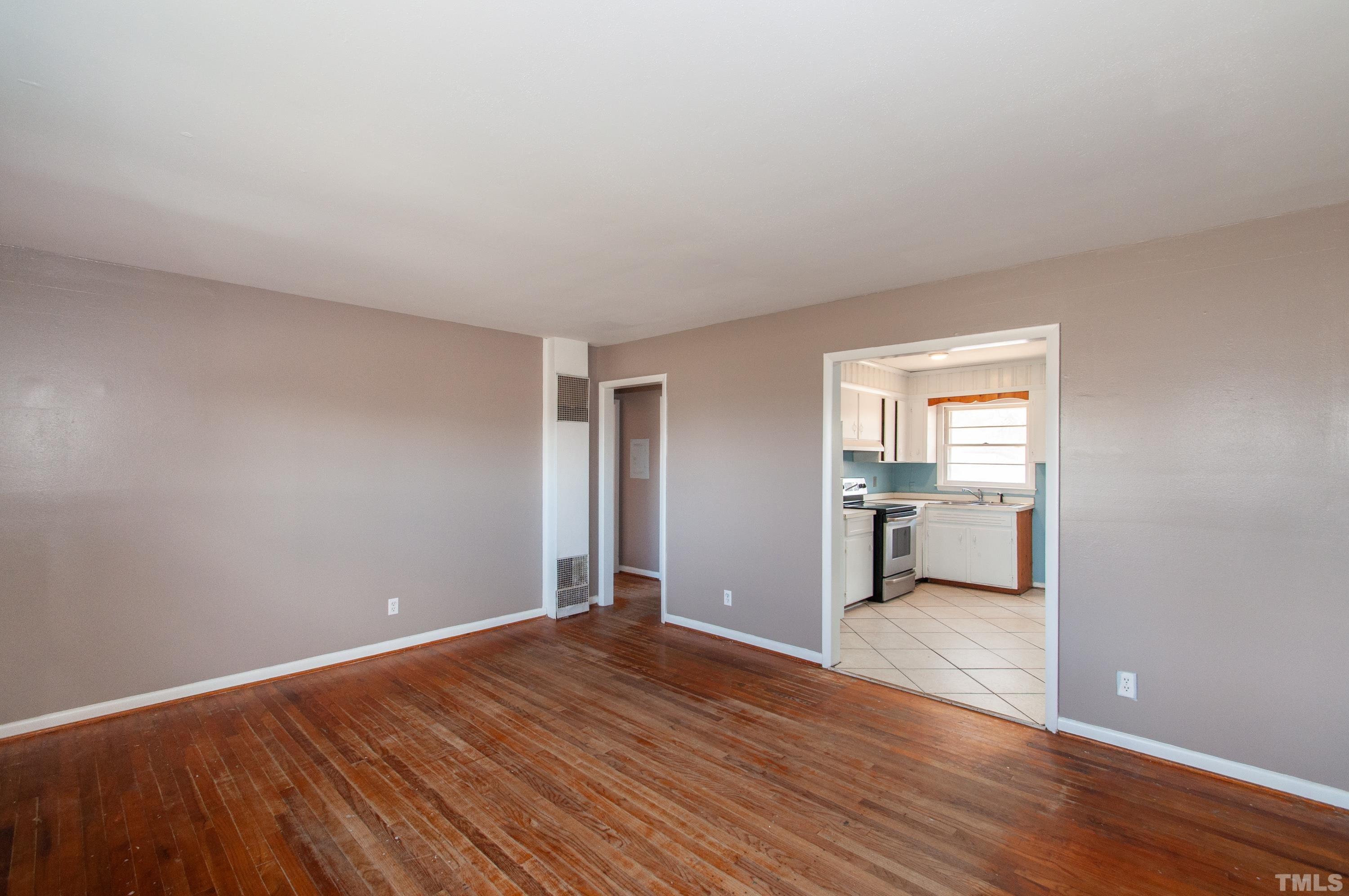 4260 Louisburg Road Raleigh, NC 27604 - Photo 6 of 22 a big room with wooden floor and windows