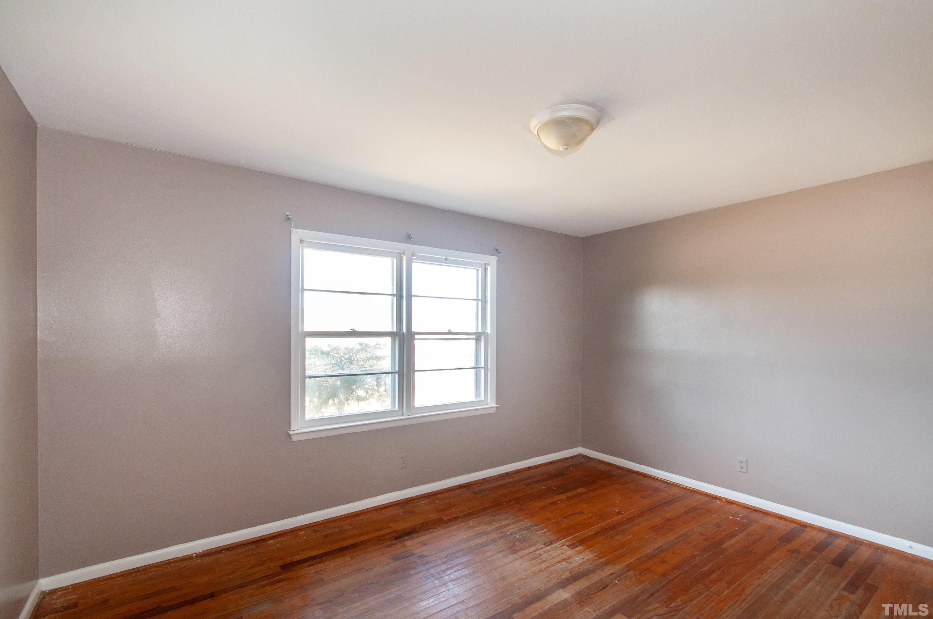 4260 Louisburg Road Raleigh, NC 27604 - Photo 22 of 22 an empty room with wooden floor and windows