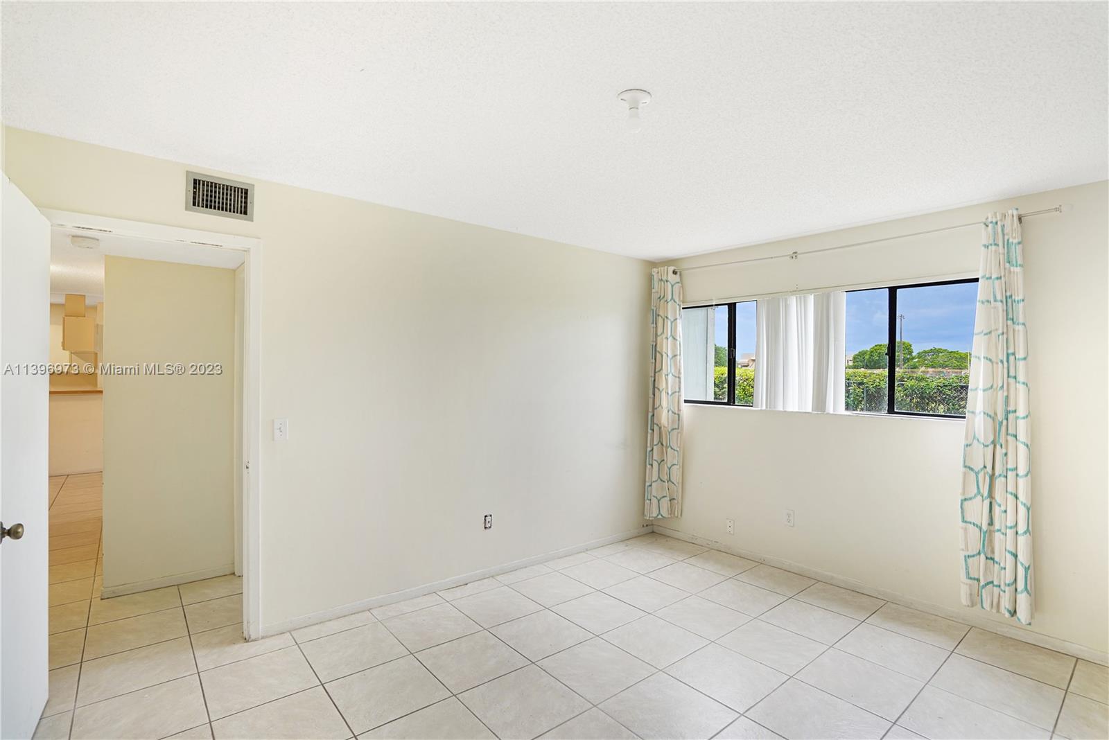 9727 Hammocks Boulevard, Unit 103D Miami, FL 33196 - Photo 12 of 19 a view of an empty room