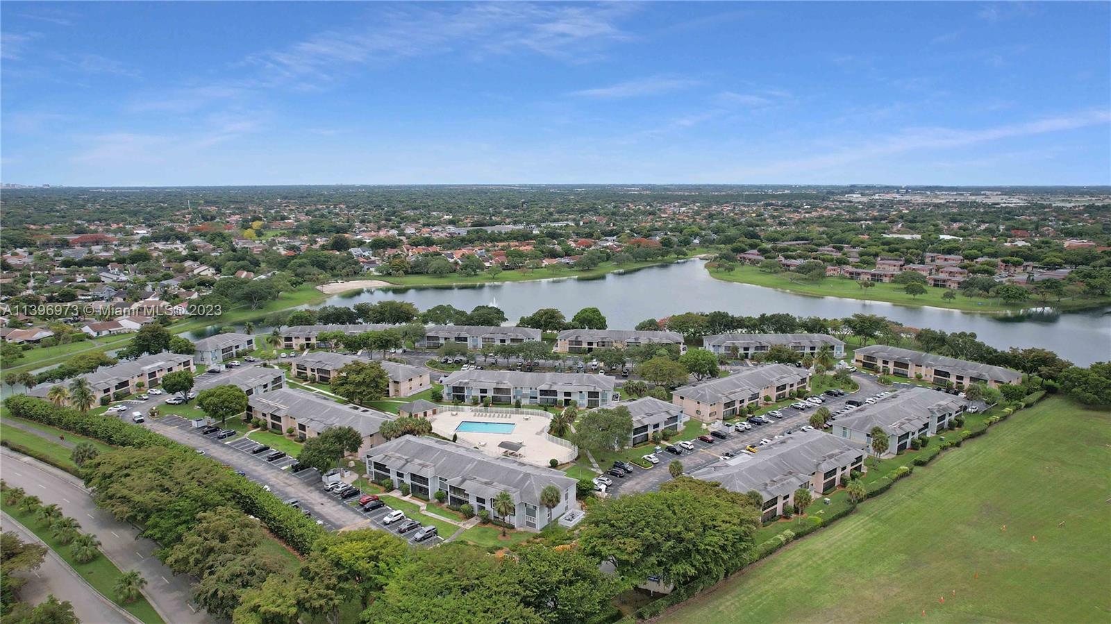 9727 Hammocks Boulevard, Unit 103D Miami, FL 33196 - Photo 3 of 19 an aerial view of a city with lots of residential buildings