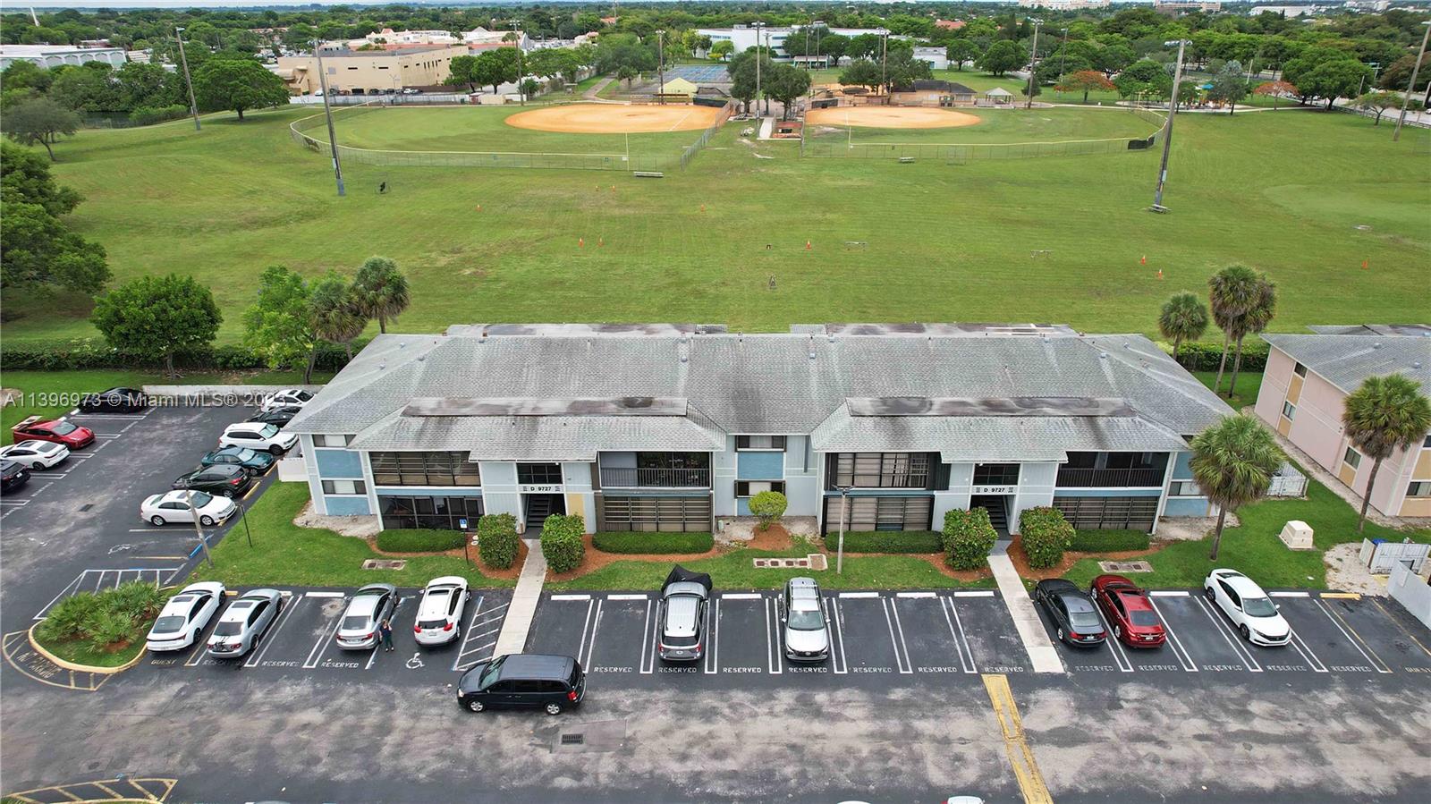 9727 Hammocks Boulevard, Unit 103D Miami, FL 33196 - Photo 5 of 19 an aerial view of a house with garden space and street view