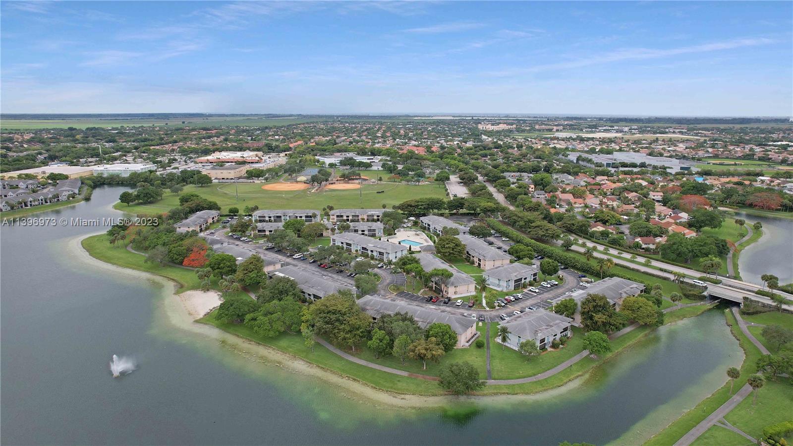 9727 Hammocks Boulevard, Unit 103D Miami, FL 33196 - Photo 6 of 19 an aerial view of a residential houses with outdoor space and trees