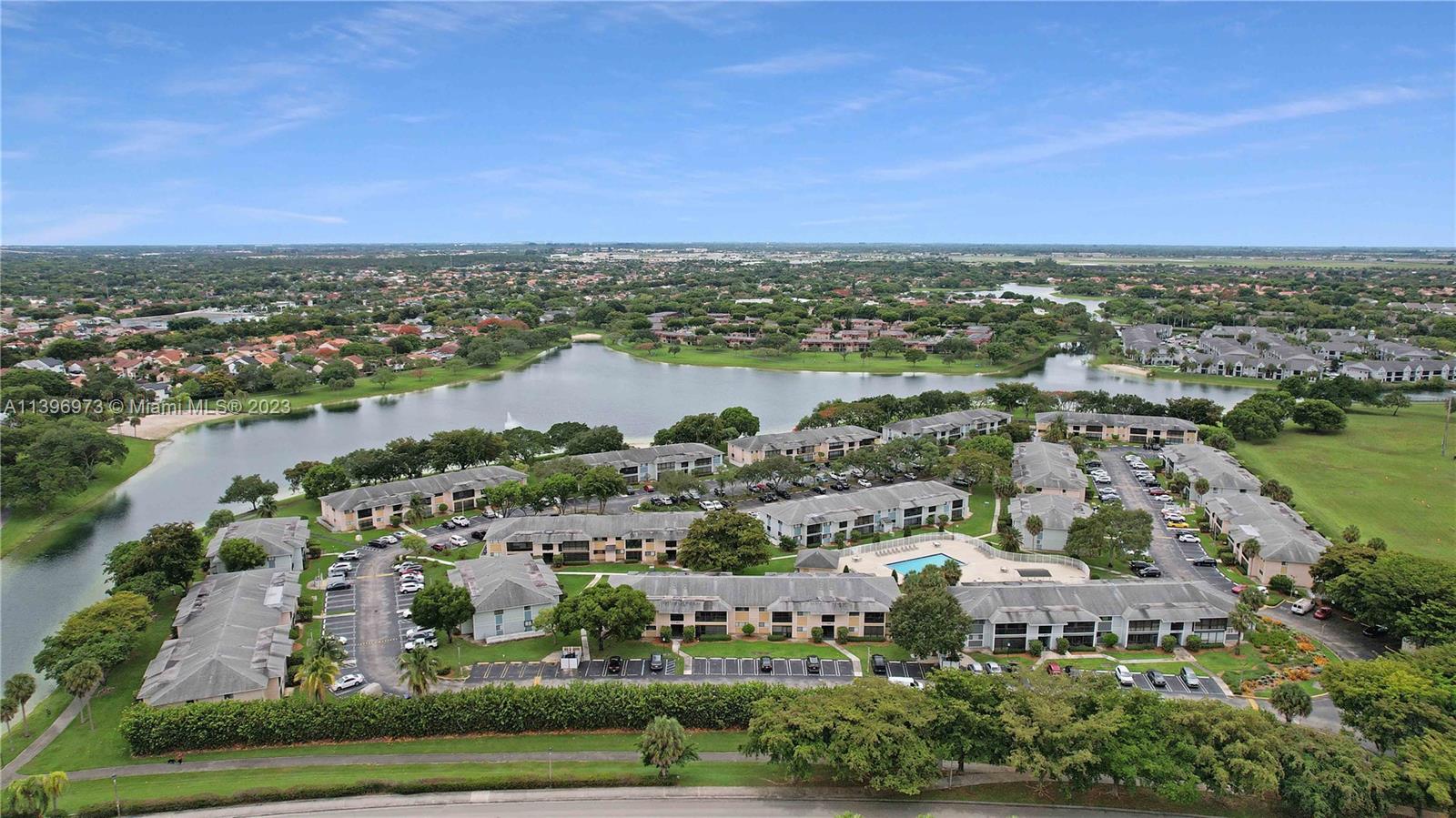 9727 Hammocks Boulevard, Unit 103D Miami, FL 33196 - Photo 8 of 19 an aerial view of residential building and lake