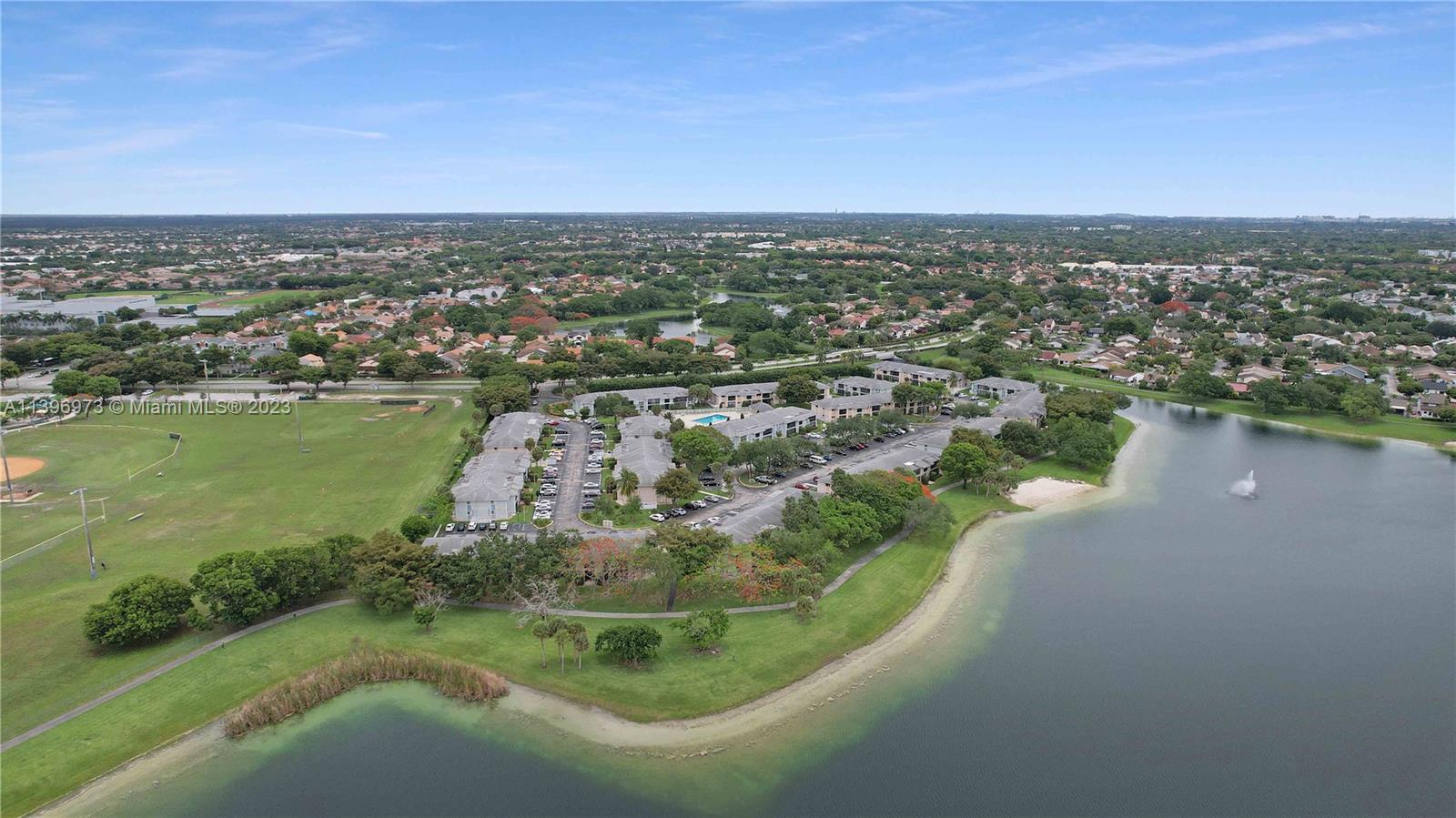 9727 Hammocks Boulevard, Unit 103D Miami, FL 33196 - Photo 9 of 19 an aerial view of a houses with a lake view
