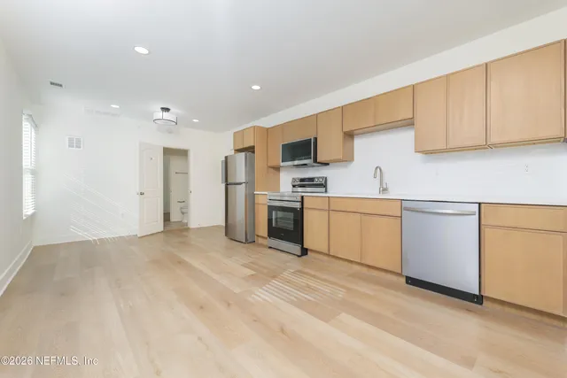 a view of a kitchen with electric appliances