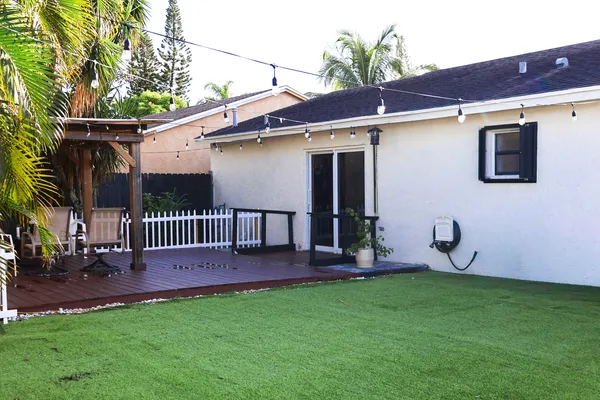 a view of a backyard with a patio and a garden