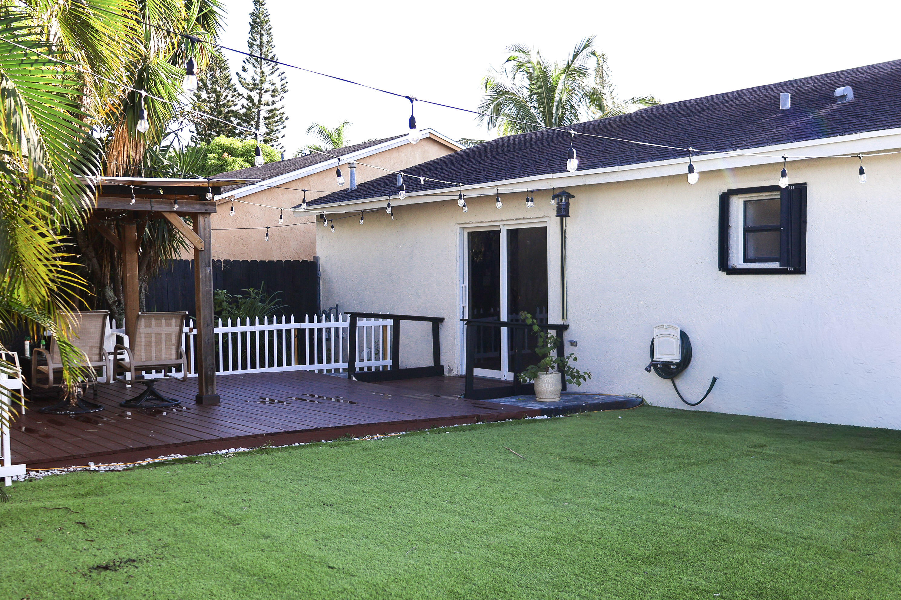 5905 Triphammer Road Lake Worth, FL 33463 - Photo 14 of 16 a view of a backyard with a patio and a garden